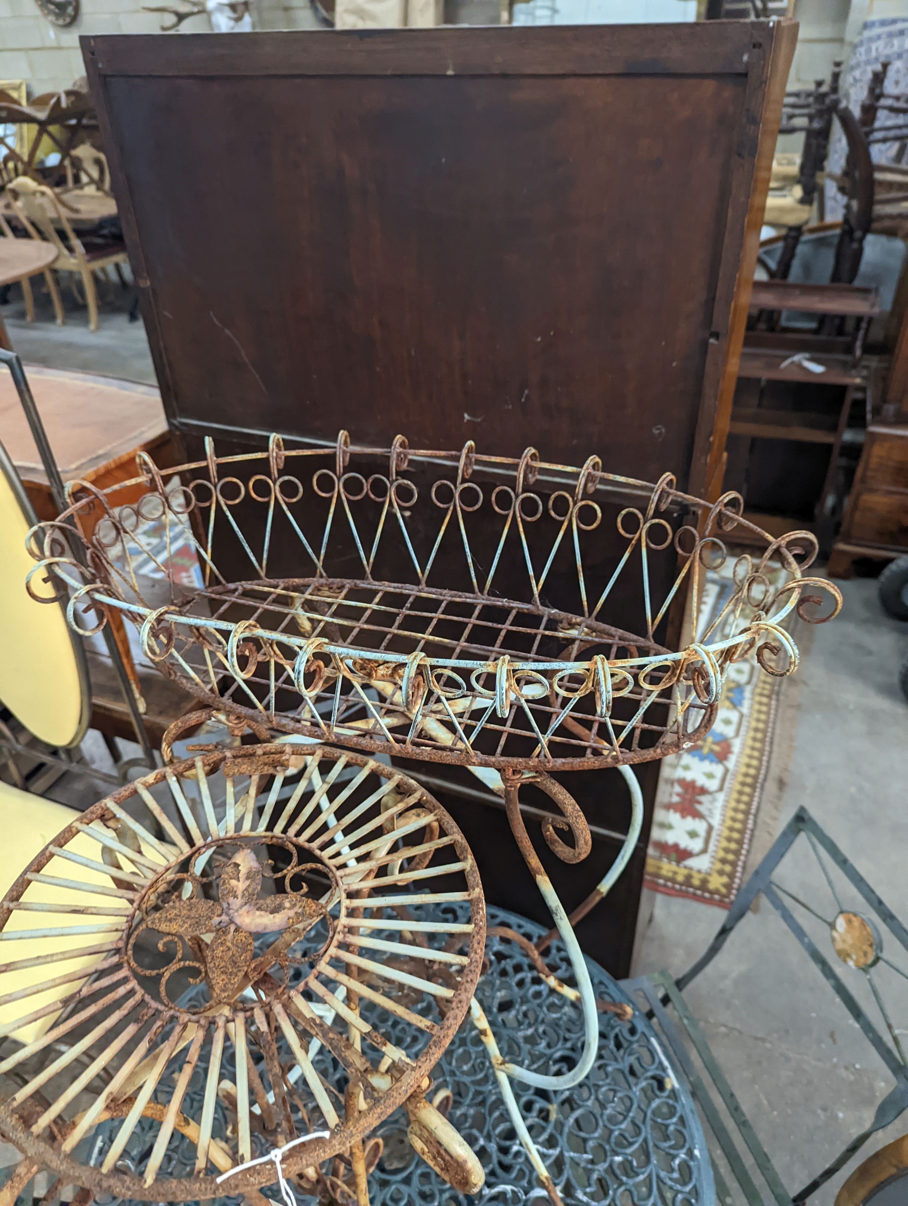 A painted wirework and wrought iron pot stand, height 79cm together with a similar circular table